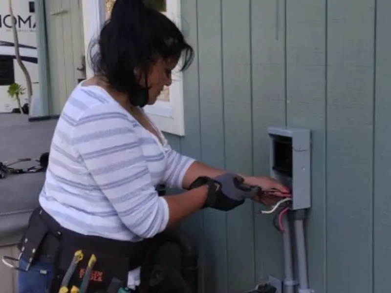 Licensed electrician wiring an exterior subpanel in Lexington